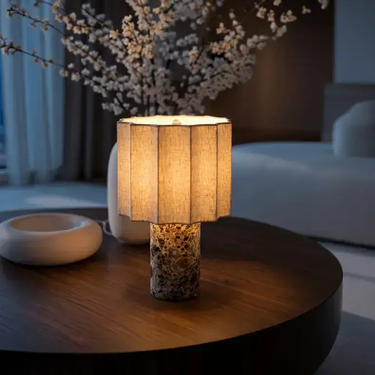 Petra lamp in Kastano marble on a walnut coffee table — evening